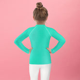 Child wearing Woodland Elf Mischief Rash Guard while playing outdoors.